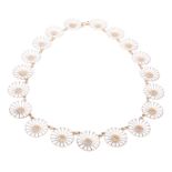 A Georg Jensen nineteen link silver gilt and white enamel daisy link necklace, length 39cm.