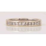 A half eternity ring, channel set, with eleven Princess cut diamonds, total weight approx. 0.