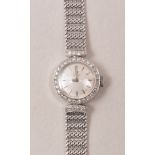 A lady's Omega wristwatch, circular baton dial, diamond set bezel, in an 18ct white gold case,