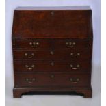 A George III oak bureau, fall front enclosing a fitted interior with drawers,