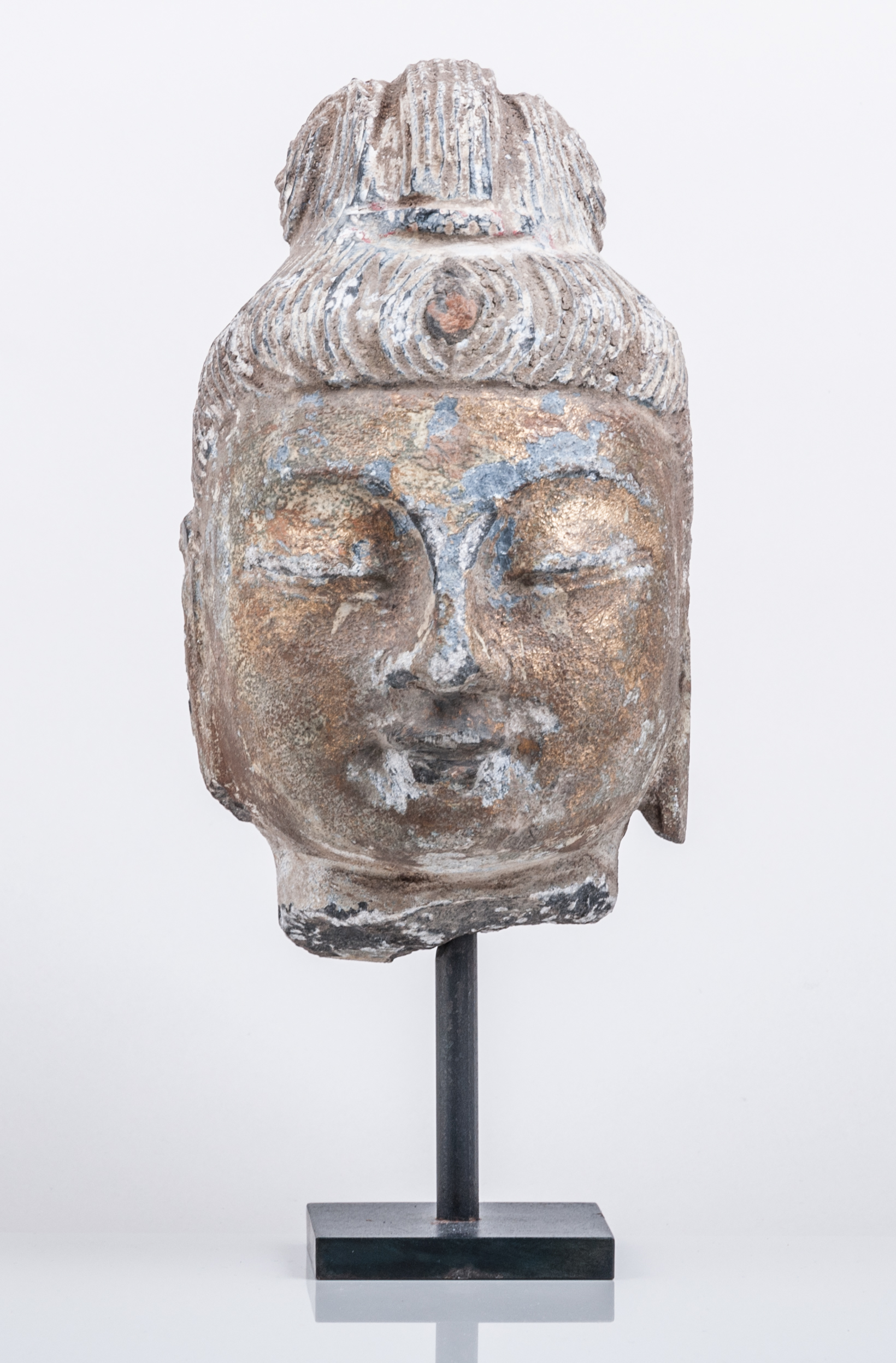 A Chinese stone head, probably Guanyin, perhaps Ming Dynasty, ornamented hair drawn back,