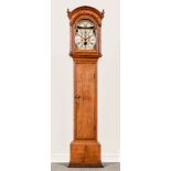 An oak longcase clock, arched brass dial,