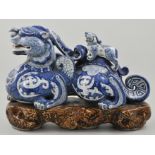 Chinese Kylin dog, blue and white sculpture, accompanied with a smaller Kylin dog to back,