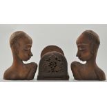 Two carved hardwood extended book racks, two carved wood lamp bases and a pair of busts,