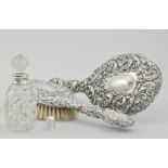 Cut glass scent bottle with a silver collar, London 1922, a silver backed hair brush, Chester 1903,