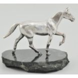 Silver model of a horse, by A E Jones, Birmingham 1970, on a black marble base, 11cm.