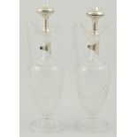 Matched pair of Continental pedestal claret jugs, with white metal stoppers and labels, 34cm.