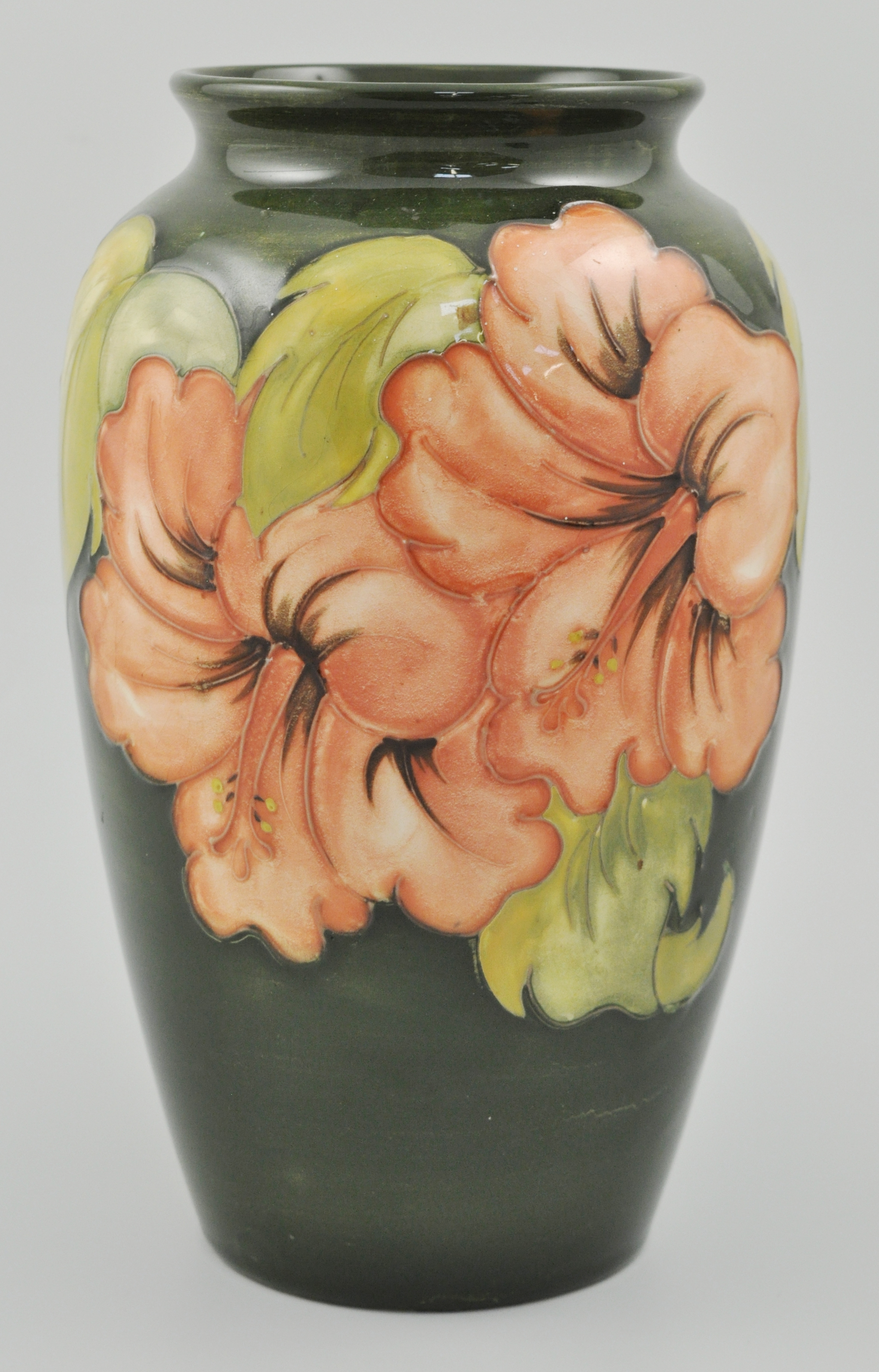 Walter Moorcroft ovoid vase, decorated in the Hibiscus pattern on a green ground, height 22cms.