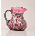 Cranberry glass jug, white metal overlaid, 10cm.