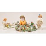 Crown Staffordshire figure of a boy, modelled by T Bayley, 21cm and two Karl Ens figures.