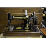 Singer sewing machine in a walnut case.