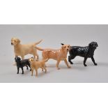 Beswick model of a black labrador, standing, 13cm and four other models of Beswick Labradors, (5).