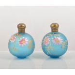 Pair of blue tinted satin glass scent bottles, enamel decoration, 10cm,