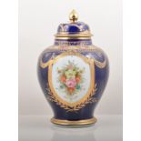 Noritake baluster shaped blue ground vase, painted floral reserves, domed lid,