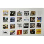 The Beatles:  framed arrangement of twenty four facsimile record sleeves, each of small size,
