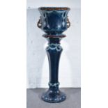 An English jardiniere on stand, circa 1910, deep sea blue ground,