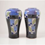 Doulton Lambeth, a pair of stoneware vases, circa 1910, with panels of stylised flowers and berries,