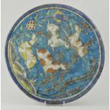 Persian Quajar circular tile, 19th Century or earlier, decorated frolicking deer amongst foliage,