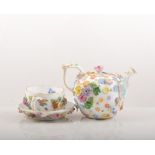 Meissen porcelain teapot, encrusted floral decoration, 7cm, a similar milk jug, a cup and saucer,