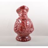 Red glazed pottery figure Wemyss style, The Sailor, 28cm and a Wemyss style model of a pig, (2).