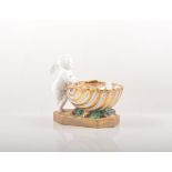 Continental porcelain ink stand, modelled with a Bisque cherub by a scallop, depth 13cm.