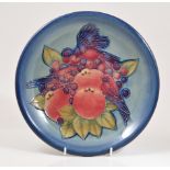 Sally Tuffin for Moorcroft Pottery, a 'Finches' plate, smokey ground, factory marks, diameter 26cm.