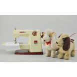 Tin plate Vulcan Countess sewing machine and two Japanese battery operated dogs.