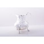 A George III Irish silver pear shaped jug, Dublin circa 1749, wrythen fluted bands,