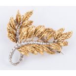 An 18 carat yellow and white gold textured leaf design spray brooch,