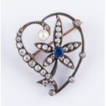 A  diamond and sapphire yellow and white metal open heart shape brooch,