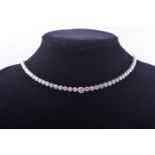 A graduating diamond set necklace individually collet set with 110 brilliant cut diamonds in an