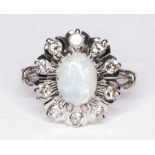 An opal and diamond oval cluster ring, the oval cabochon cut opal 8.5mm x 6.
