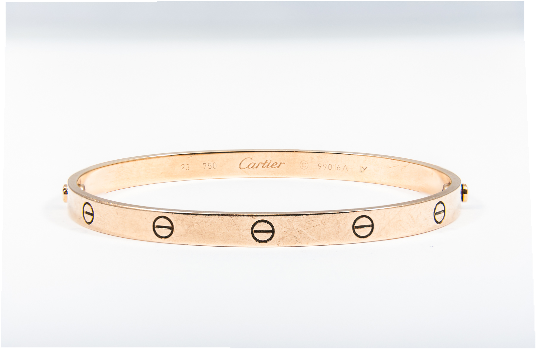 Cartier - An 18 carat yellow gold "Love Bangle" decorated with a number of screw head motifs.