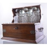 A late Victorian oak tantalus, with nickel plated mounts,