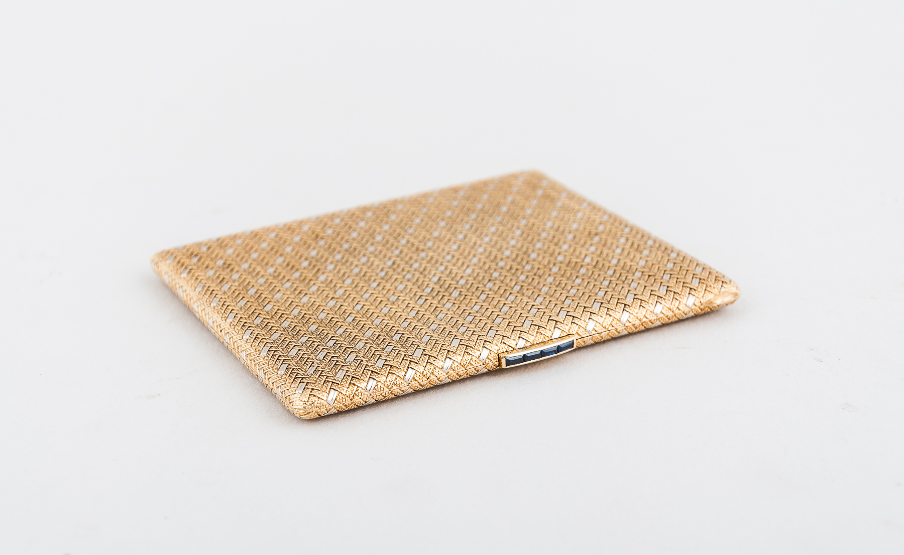 A two-colour yellow and white metal cigarette case, basket weave design,