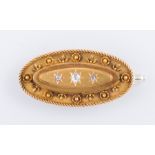 A hallmarked 15 carat yellow gold oval bar brooch of Etruscan style,