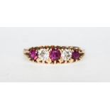 A traditional ruby and diamond half hoop ring, claw set with rubies (2) and diamonds (3),