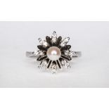 A diamond and pearl set floral design dress ring,