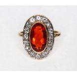 A Mexican fire opal and diamond oval cluster ring, the oval mixed cut opal 12.2mm x 7.