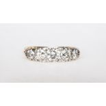 A traditional diamond half hoop ring, claw set with diamonds (5), brilliant cut stones,