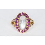 A moonstone and ruby oval cluster ring, the oval cabochon cut moonstone 10.