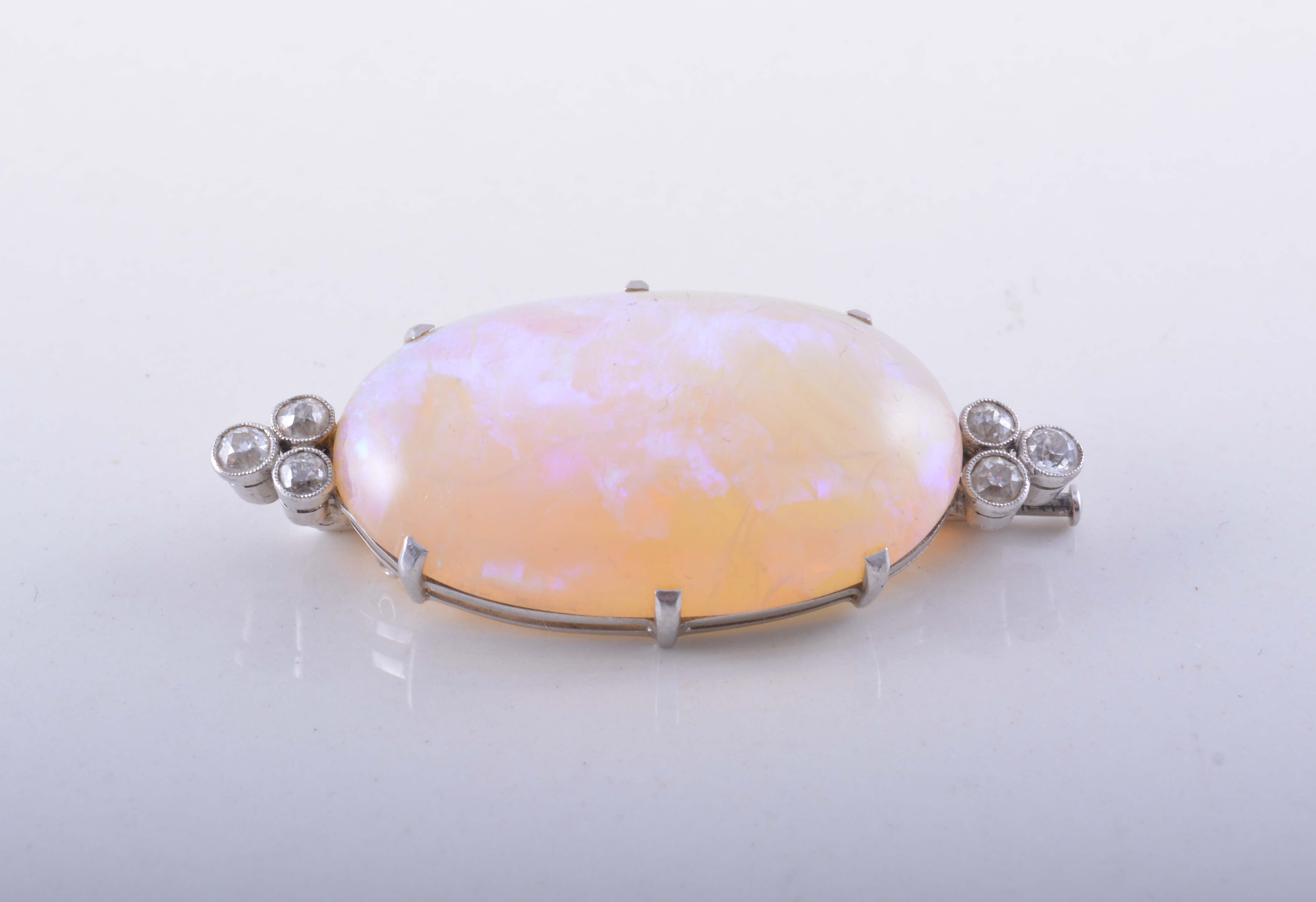 An opal and diamond brooch,