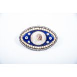 A lozenge shaped blue enamel, half pearl and diamond brooch,