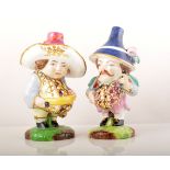 A pair of Derby style porcelain models of Mansion House Dwarfs,