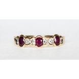 A modern ruby and diamond half eternity ring with three oval mixed cut rubies spaced by six