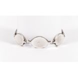 Georg Jensen - A silver bracelet of seven polished oval links with one incorporating the tongue