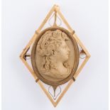 An oval carved Lava cameo of female profile collet set brooch,