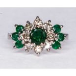 An emerald and diamond circular cluster ring,