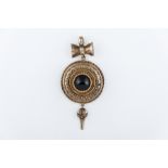 A yellow metal Etruscan style circular domed target pendant,