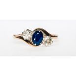 A traditional diamond and sapphire crossover ring,
